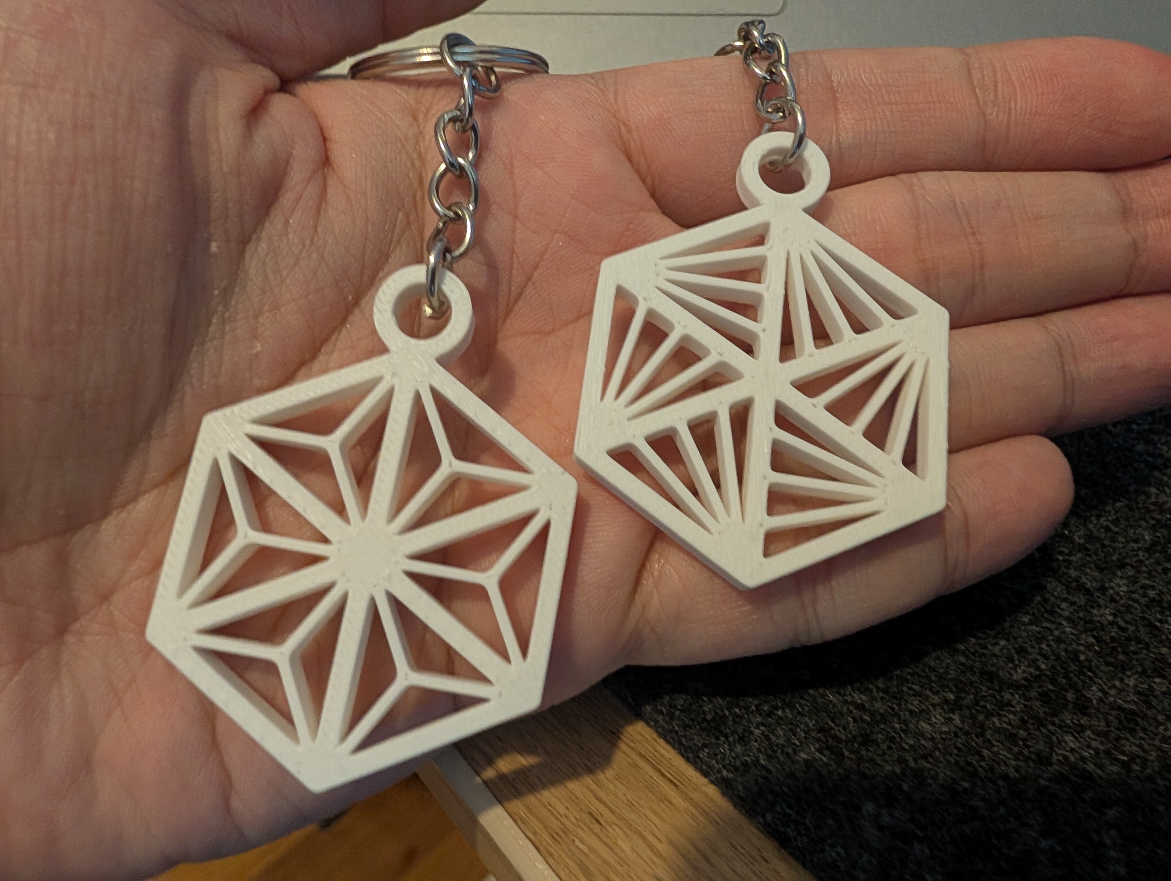 3D printed Kumiko keychains in crisp white PLA showing Asa-no-ha and variant patterns